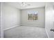 Well-lit bedroom with grey carpet and a large window at 3207 Stratton Cir, Kissimmee, FL 34744