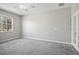 Bright bedroom featuring grey carpet and a large window at 3207 Stratton Cir, Kissimmee, FL 34744