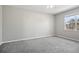 Bedroom with grey carpet, large window, and ceiling fan at 3207 Stratton Cir, Kissimmee, FL 34744