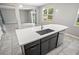 Kitchen island with seating space, stainless steel sink, and modern faucet at 3207 Stratton Cir, Kissimmee, FL 34744