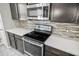 Modern kitchen with stainless steel appliances and a quartz countertop at 3207 Stratton Cir, Kissimmee, FL 34744