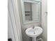 Modern powder room with pedestal sink and decorative mirror at 3207 Stratton Cir, Kissimmee, FL 34744