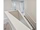 Modern staircase leading to the second floor with gray carpeting and white railings at 3207 Stratton Cir, Kissimmee, FL 34744