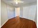 Bedroom with wood floors, double door closet and ceiling fan at 4134 Tunitas Ct, Orlando, FL 32817