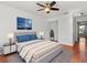 Bedroom with a gray bed, blue accents, and a ceiling fan at 4717 Capri Pl # 193, Orlando, FL 32811