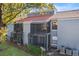 Rear view of the property showcasing screened patios and landscaping at 4717 Capri Pl # 193, Orlando, FL 32811