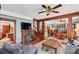 Spacious living room featuring hardwood floors, fireplace, and built-in shelving at 523 Pennsylvania Ave, Saint Cloud, FL 34769