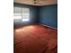 Bedroom with blue walls, red carpet, and a window at 545 Silver Course Cir, Ocala, FL 34472