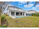 Home with pool, patio, and grassy backyard at 7457 Marker Ave, Kissimmee, FL 34747