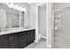 Elegant bathroom with double vanity, large mirror, and glass shower enclosure at 7457 Marker Ave, Kissimmee, FL 34747