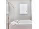 Relaxing bathroom with a large garden tub and a mirrored shower enclosure at 7457 Marker Ave, Kissimmee, FL 34747