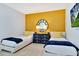 Twin bedroom with mustard yellow accent wall and matching decor at 7457 Marker Ave, Kissimmee, FL 34747