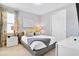 Bedroom with gray platform bed and yellow accents at 7457 Marker Ave, Kissimmee, FL 34747