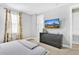 Bedroom with gray dresser and large window at 7457 Marker Ave, Kissimmee, FL 34747