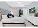 Main bedroom with a gray upholstered bed and access to the backyard at 7457 Marker Ave, Kissimmee, FL 34747