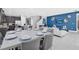 Dining area with large table and gray chairs, overlooking kitchen and living room at 7457 Marker Ave, Kissimmee, FL 34747