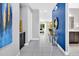 Bright entryway with tile floors, blue accent wall, and a view into the living room at 7457 Marker Ave, Kissimmee, FL 34747