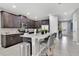 Modern kitchen with dark brown cabinets, quartz countertops, and stainless steel appliances at 7457 Marker Ave, Kissimmee, FL 34747