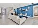 Open concept living room with white sectional sofa and blue accent wall at 7457 Marker Ave, Kissimmee, FL 34747