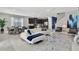 Open floor plan with white sectional sofa, dining area, and modern kitchen at 7457 Marker Ave, Kissimmee, FL 34747
