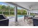 Spacious covered patio with outdoor dining and a built-in grill at 7457 Marker Ave, Kissimmee, FL 34747