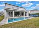 Inviting backyard oasis with a pool, spa, and covered patio at 7457 Marker Ave, Kissimmee, FL 34747