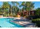 Relaxing community pool with lounge chairs and a shaded pergola at 7500 Toscana Blvd # 341, Orlando, FL 32819