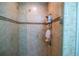 Clean and spacious shower with tiled walls at 7500 Toscana Blvd # 341, Orlando, FL 32819