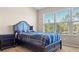 Bright bedroom with a comfortable bed and large window at 8345 Bella Tierra Ct # 8345, Davenport, FL 33896