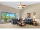 Spacious living room with high ceilings, leather sofas, and access to a screened balcony at 8345 Bella Tierra Ct # 8345, Davenport, FL 33896