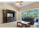 Living room with large TV, balcony access, and ample seating at 8345 Bella Tierra Ct # 8345, Davenport, FL 33896