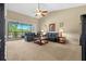 Spacious living room with high ceilings, leather sofas, and access to a screened balcony at 8345 Bella Tierra Ct # 8345, Davenport, FL 33896