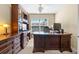 Home office with built-in cabinetry and large desk at 8345 Bella Tierra Ct # 8345, Davenport, FL 33896