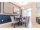 Elegant dining room with a six-person table and modern chandelier at 8943 Cabot Cliffs Dr, Davenport, FL 33896