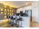 Modern kitchen with breakfast bar and dark gray cabinets at 8943 Cabot Cliffs Dr, Davenport, FL 33896