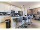 Modern kitchen with stainless steel appliances and an island with seating at 8943 Cabot Cliffs Dr, Davenport, FL 33896