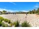 Sand volleyball court with surrounding landscaping at 8943 Cabot Cliffs Dr, Davenport, FL 33896