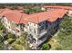 Aerial view of condo building, showing building exterior, landscaping, and community features at 904 Charo Pkwy # 525, Davenport, FL 33897