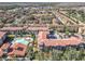 Aerial view showcasing condo location, community pool, and surrounding neighborhood at 904 Charo Pkwy # 525, Davenport, FL 33897