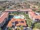 Aerial view of community with pool and Spanish-style architecture at 904 Charo Pkwy # 525, Davenport, FL 33897
