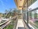 Private balcony with stone and metal railings and a view of the trees at 904 Charo Pkwy # 525, Davenport, FL 33897