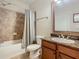 Clean bathroom with shower/tub combo, granite vanity, and mirror at 904 Charo Pkwy # 525, Davenport, FL 33897