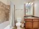 Clean bathroom with shower/tub combo, granite vanity, and mirror at 904 Charo Pkwy # 525, Davenport, FL 33897