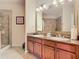 Double vanity bathroom with granite countertops and large walk-in shower at 904 Charo Pkwy # 525, Davenport, FL 33897