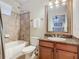 Clean bathroom with shower/tub combo, granite vanity, and mirror at 904 Charo Pkwy # 525, Davenport, FL 33897