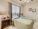 Bedroom with two twin beds, nightstand, and ceiling fan at 904 Charo Pkwy # 525, Davenport, FL 33897