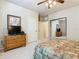 Bedroom with a king-size bed, dresser, and mirrored closet at 904 Charo Pkwy # 525, Davenport, FL 33897