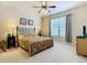 Spacious bedroom with a king-size bed, large window, and ceiling fan at 904 Charo Pkwy # 525, Davenport, FL 33897