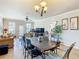 Open concept dining area with tile floors and chandelier at 904 Charo Pkwy # 525, Davenport, FL 33897