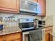 Modern kitchen with stainless steel appliances and granite countertops at 904 Charo Pkwy # 525, Davenport, FL 33897
